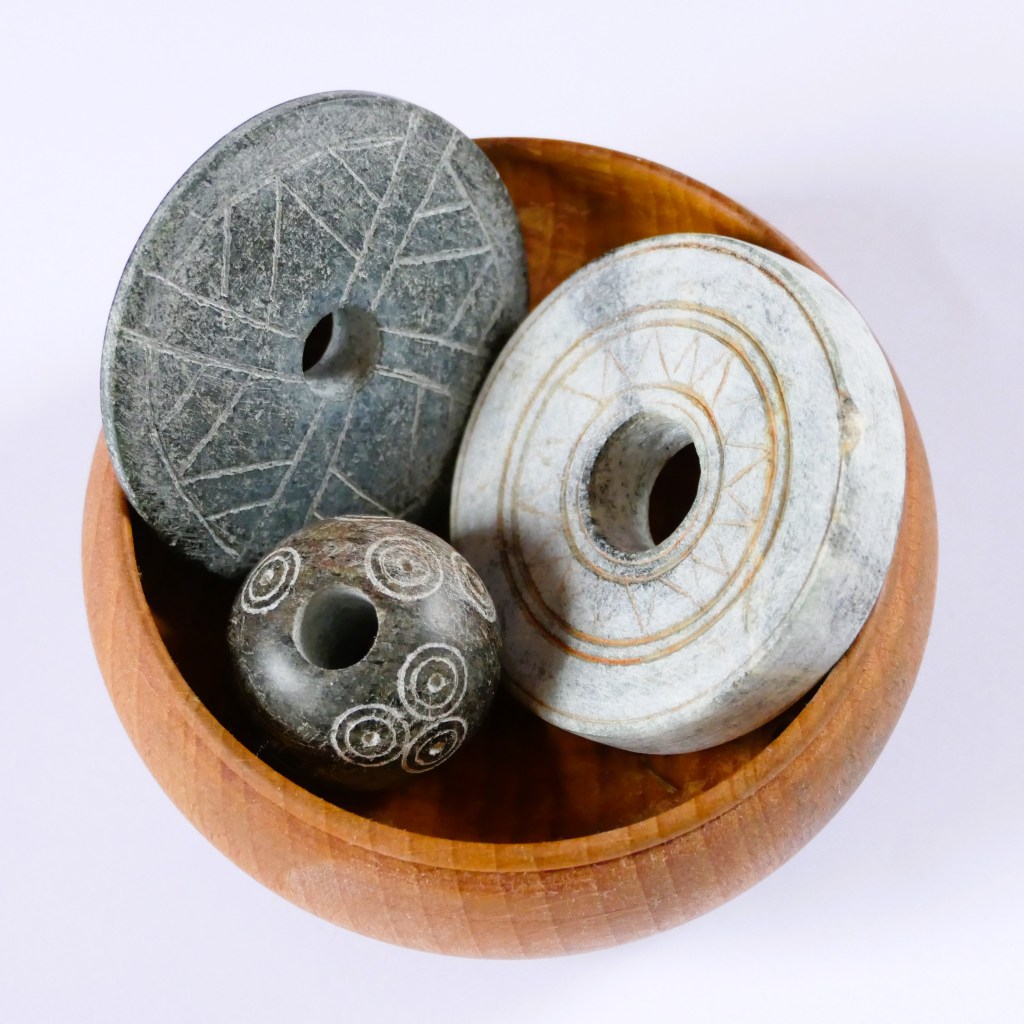 Spindle whorls from Sweden, in a yarn cup.